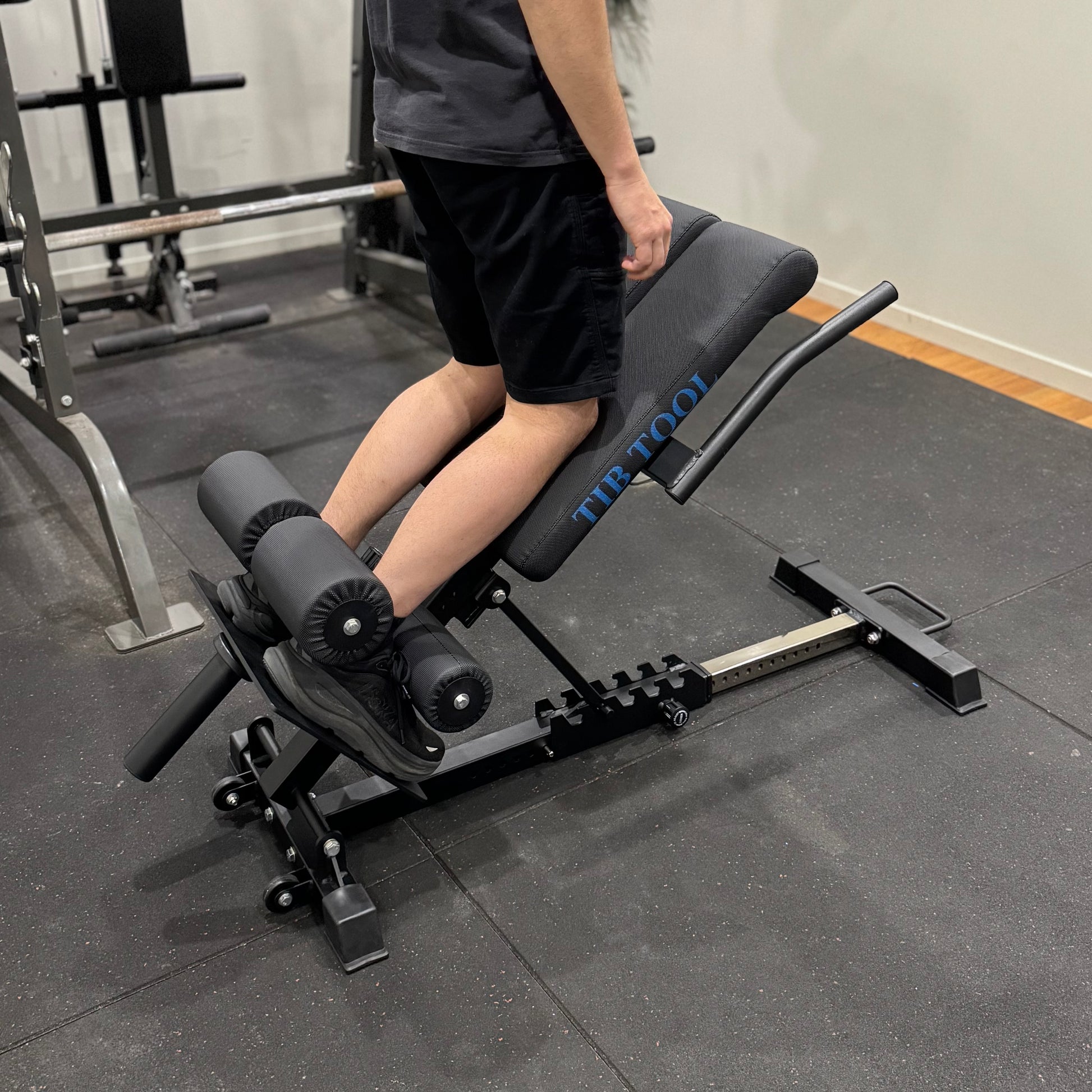 Person using a weight bench in a gym setting