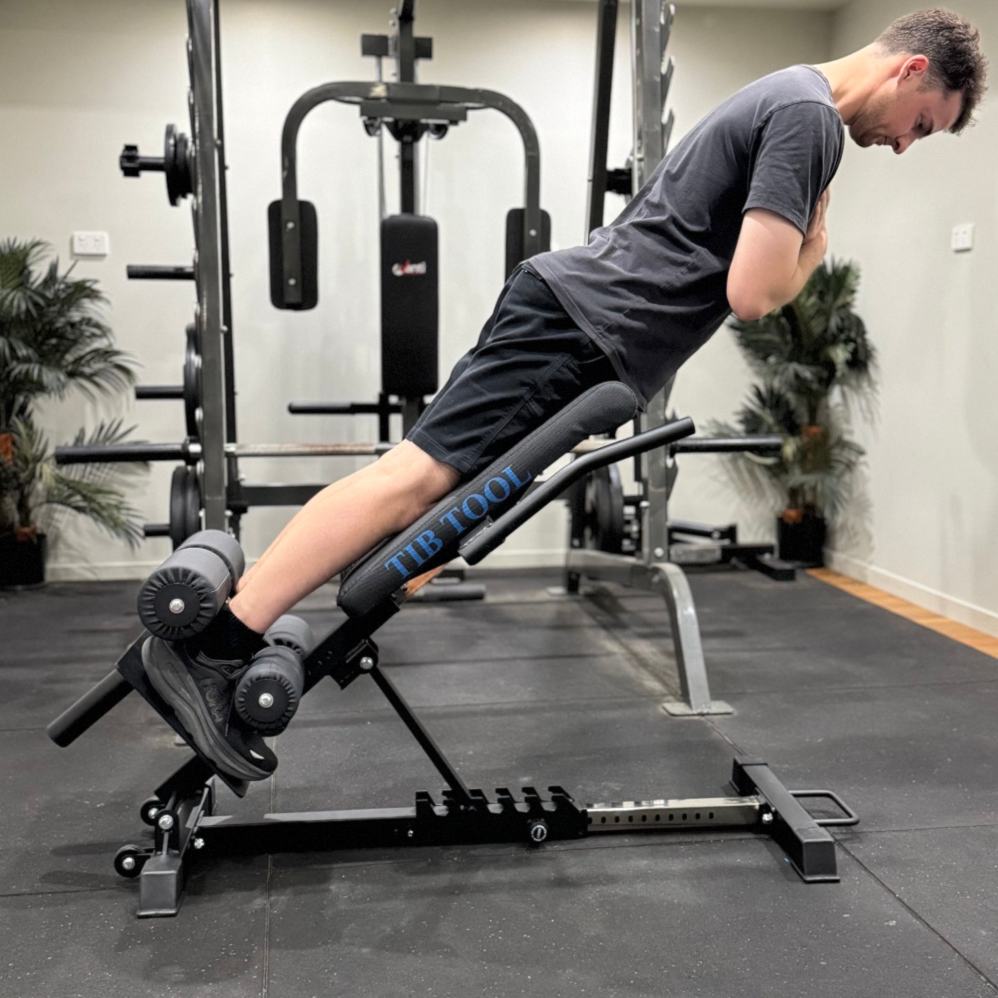 Person using a weight bench in a gym setting