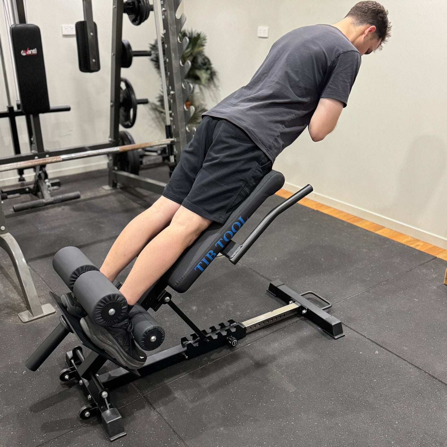 Person using a weight bench in a gym setting