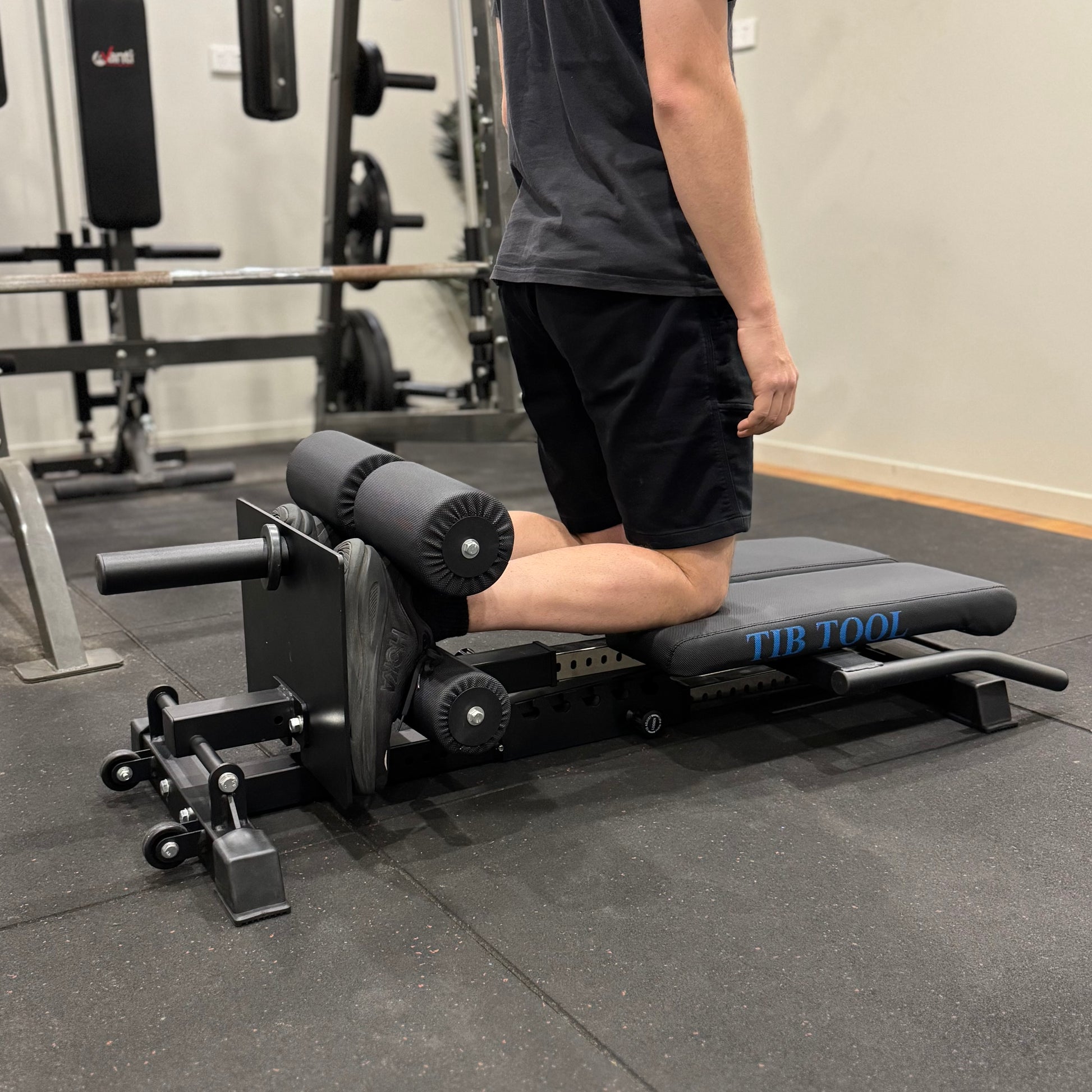 Person using a leg extension machine in a gym setting