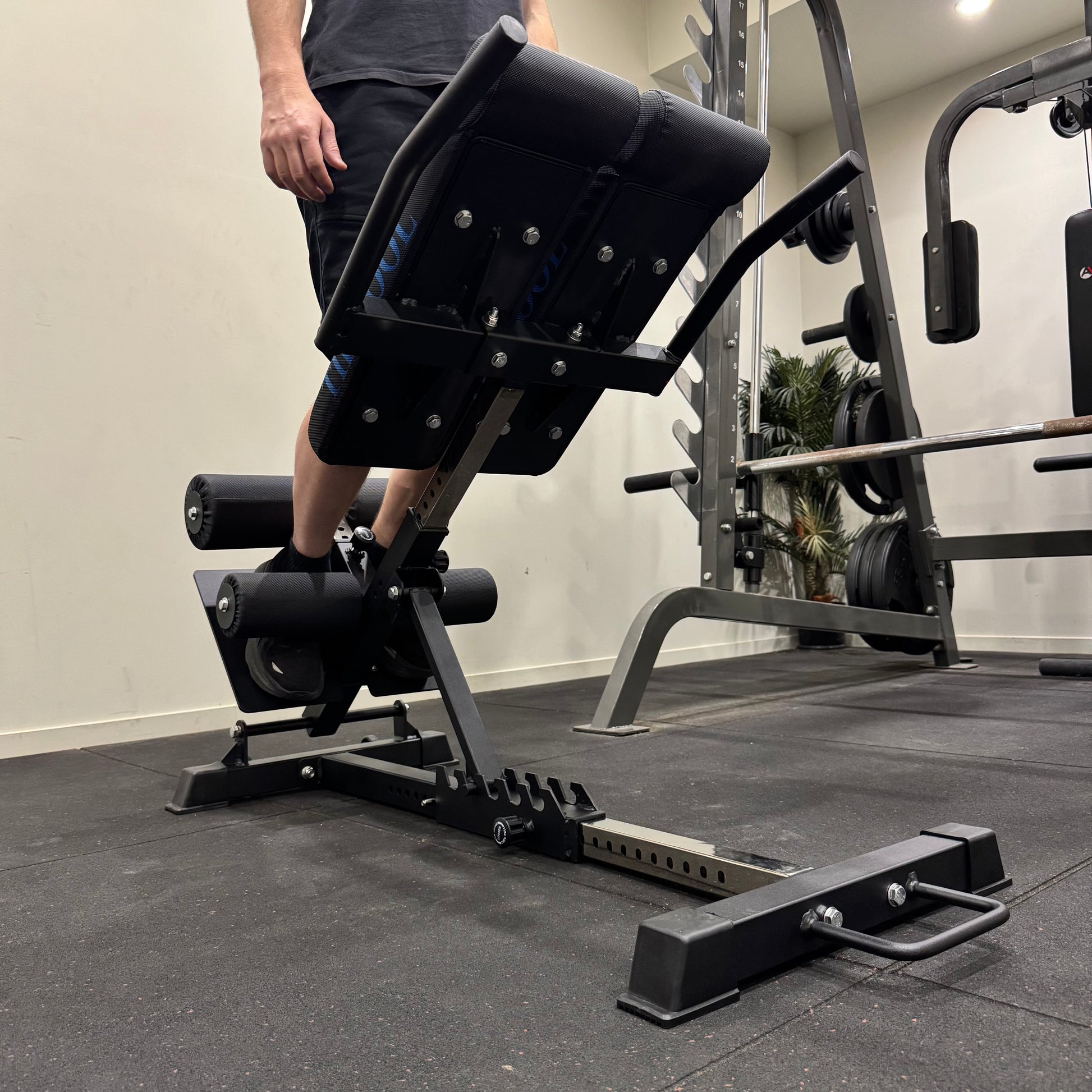 Person using a weight machine in a gym setting