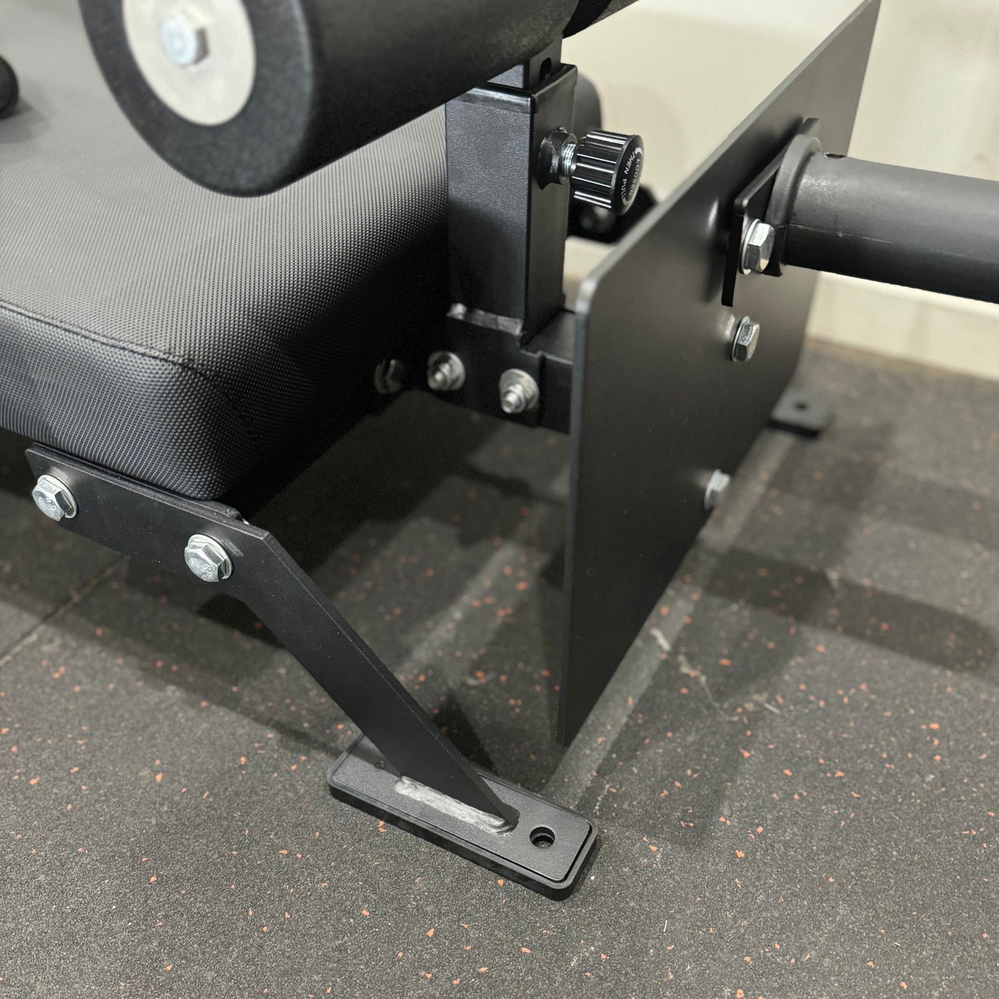 Close-up of Nordic Bar gym equipment showing the padded seat and metal frame, designed for strength training.