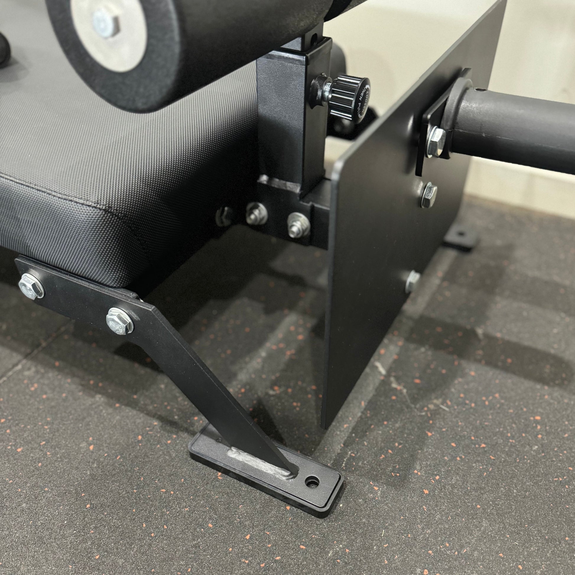 Close-up of Nordic Bar gym equipment showing the padded seat and metal frame, designed for strength training.