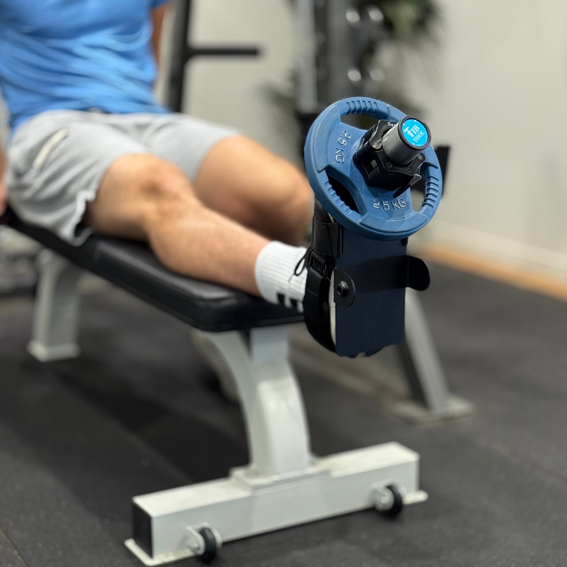 Person using a tibialis anterior tibia dorsi flex machine.