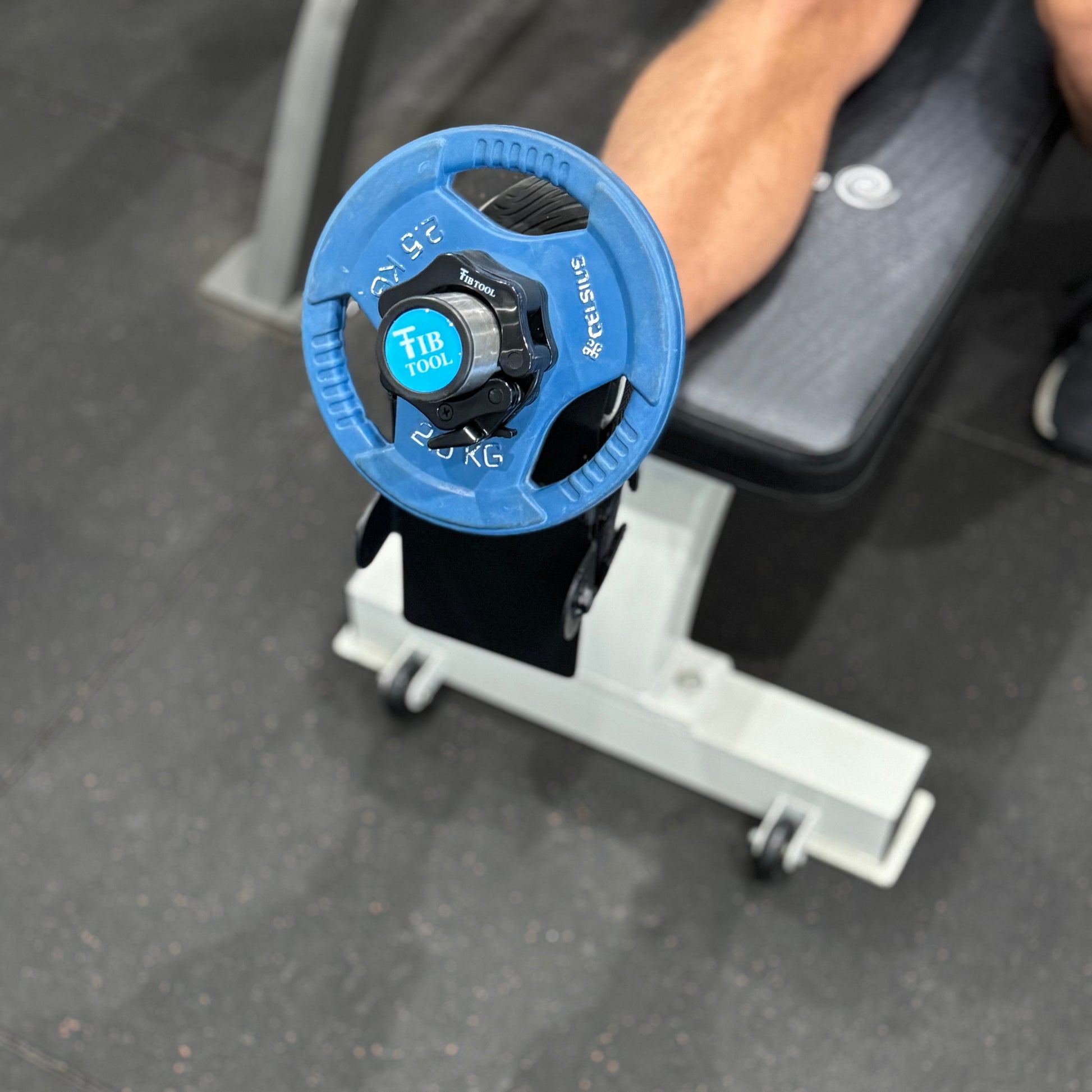 Person performing tib raises while using the tib tool tib bar single leg.