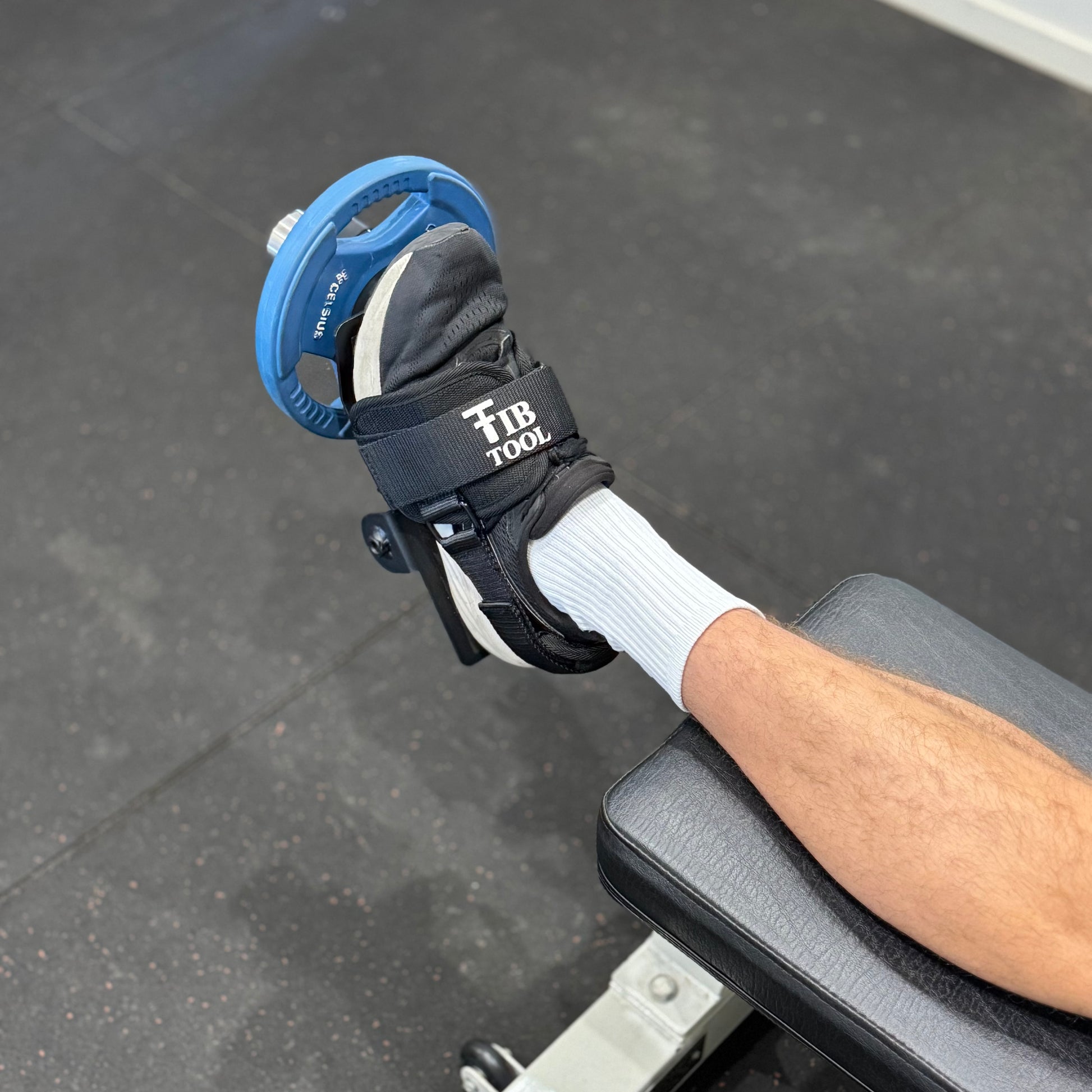 Person using a tib bar on end of bench