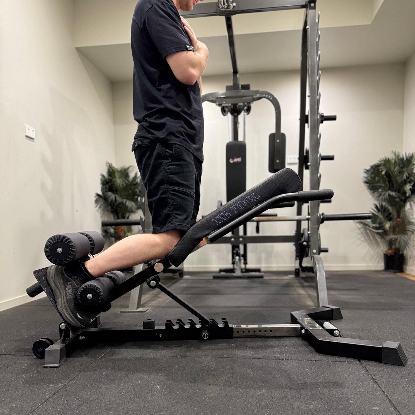 Person using a leg extension GHD machine in a gym setting