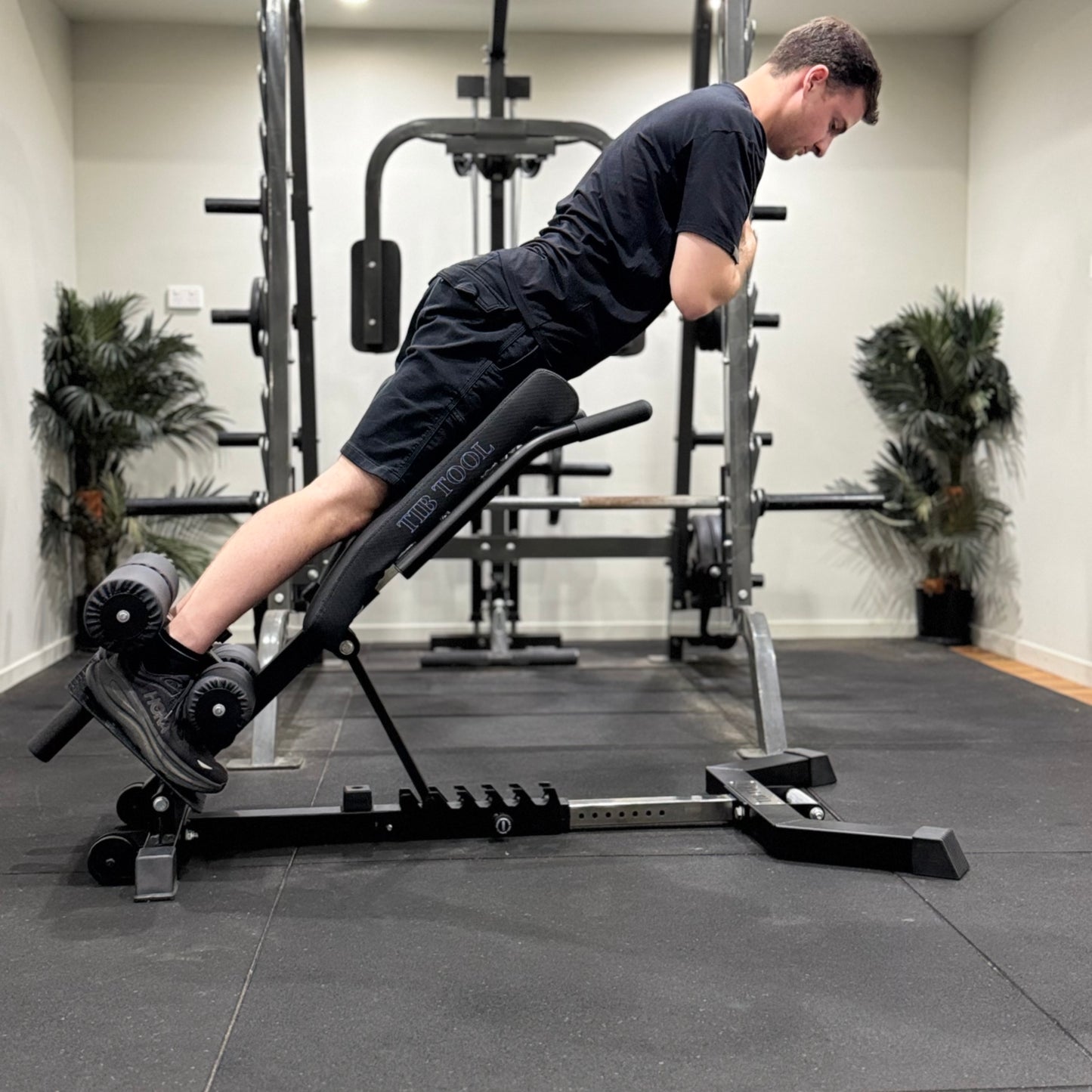 Person using a weight bench in a gym setting