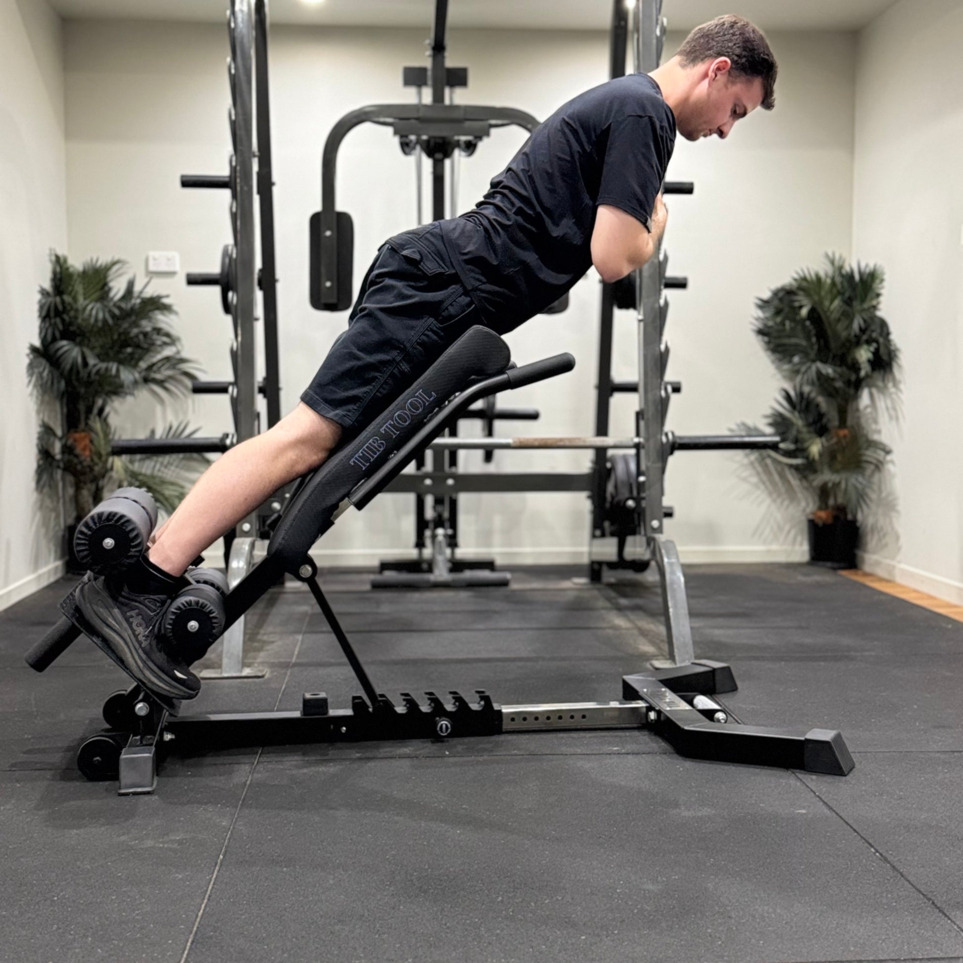 Person using a weight bench in a gym setting