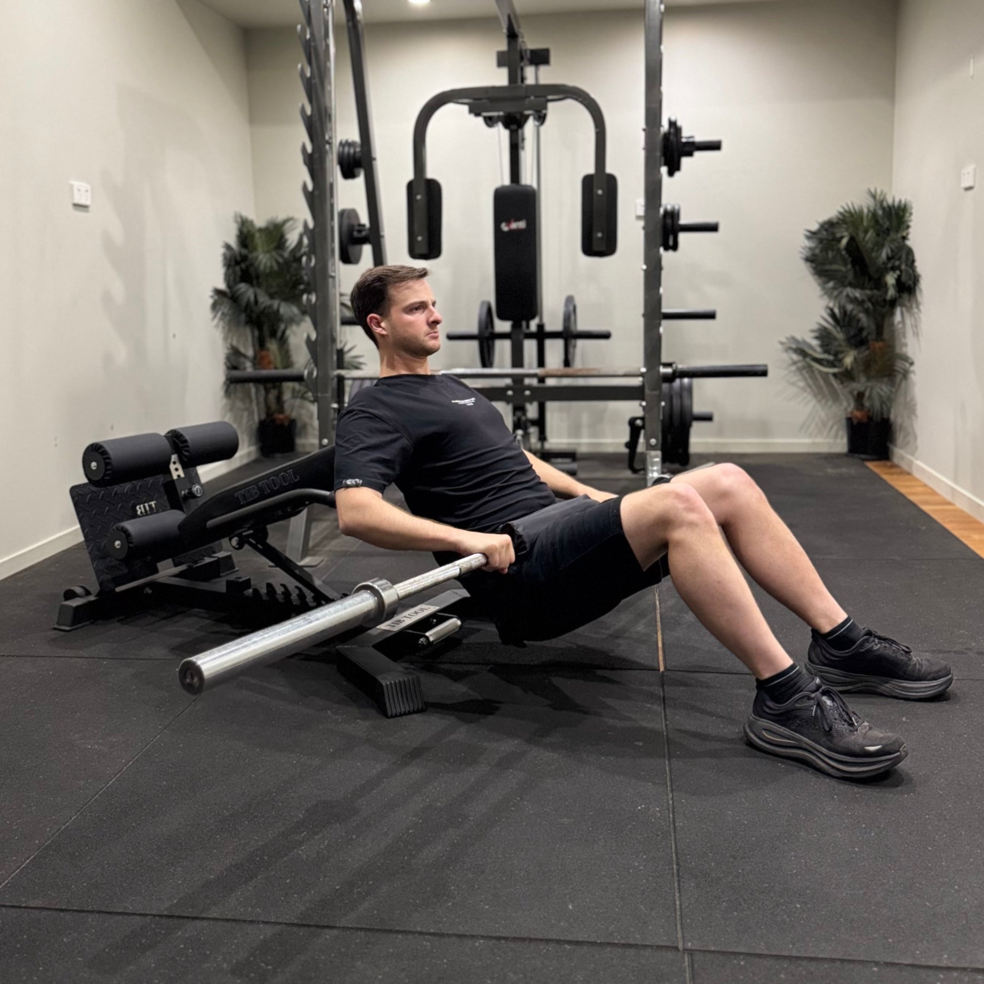Man exercising on a leg press machine in a gym setting