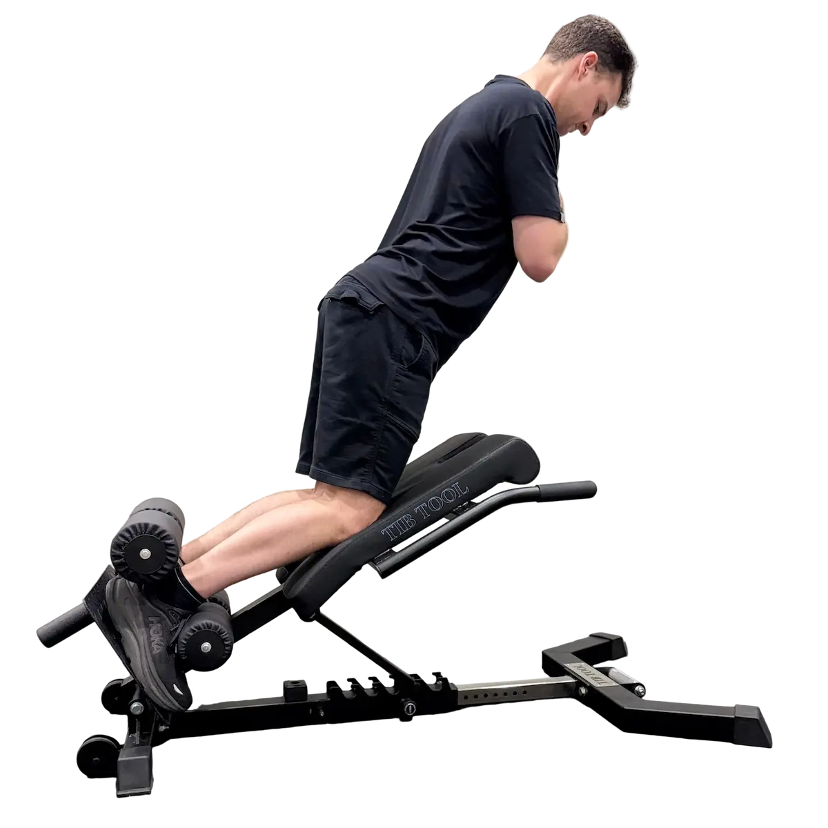 Person using a black weight Nordic curl bench on a white background