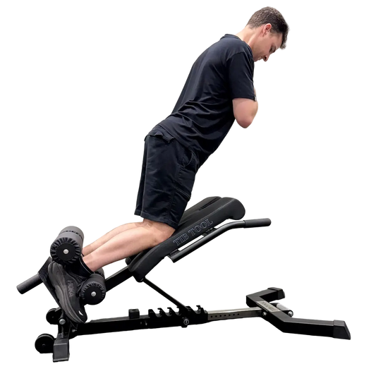 Person using a black weight Nordic curl bench on a white background