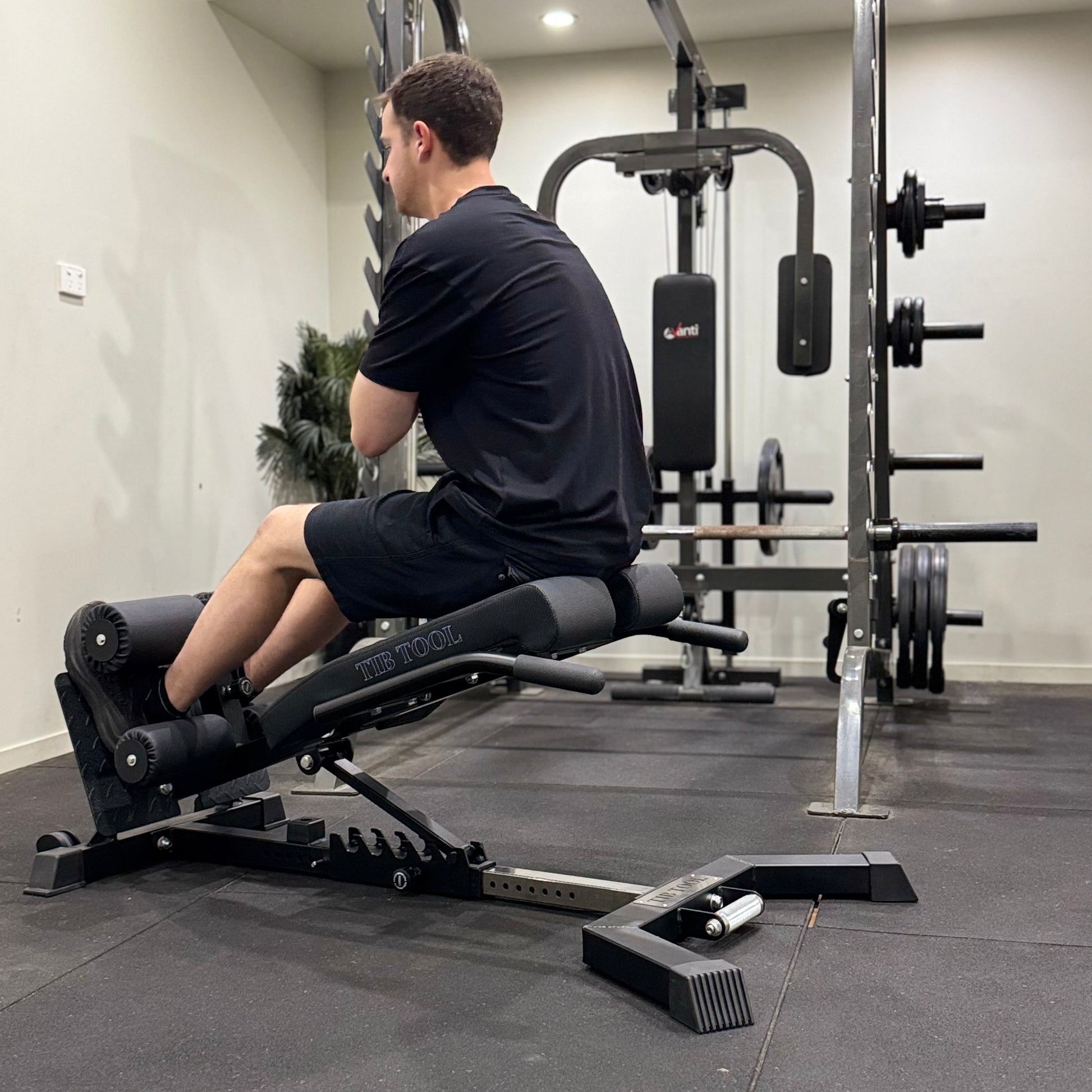 Man using a leg extension machine in a gym setting