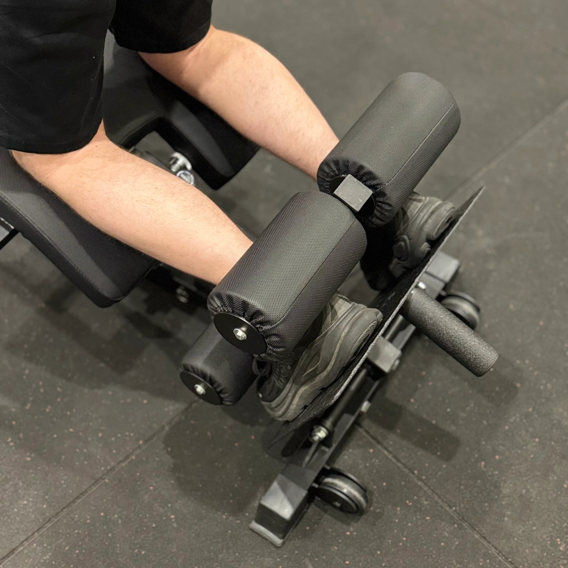 Ankle pads on a back extension machine.
