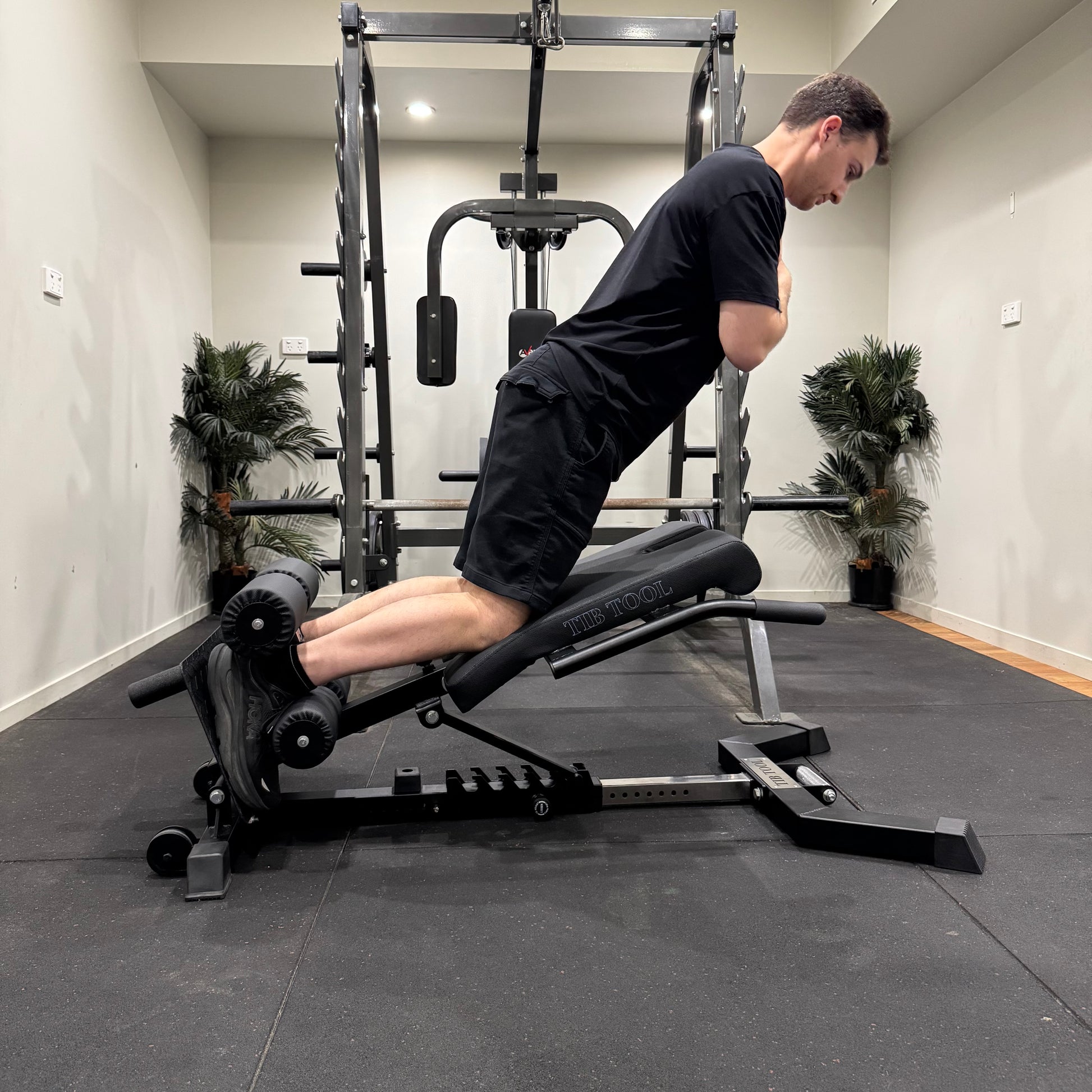 Person using a nordic weight machine in a gym setting