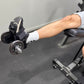 Person using ankle weights for leg extensions in a gym setting.