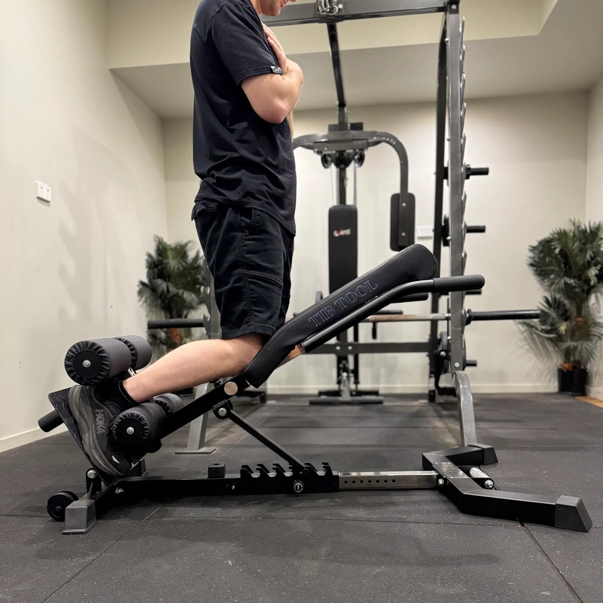 Person using a nordic curl machine in a gym setting