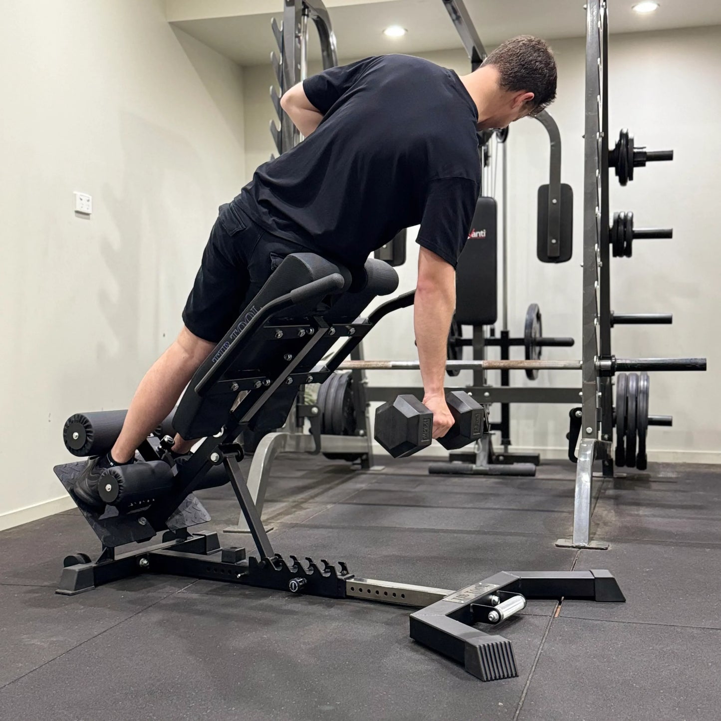 Person using a weight bench in a gym setting