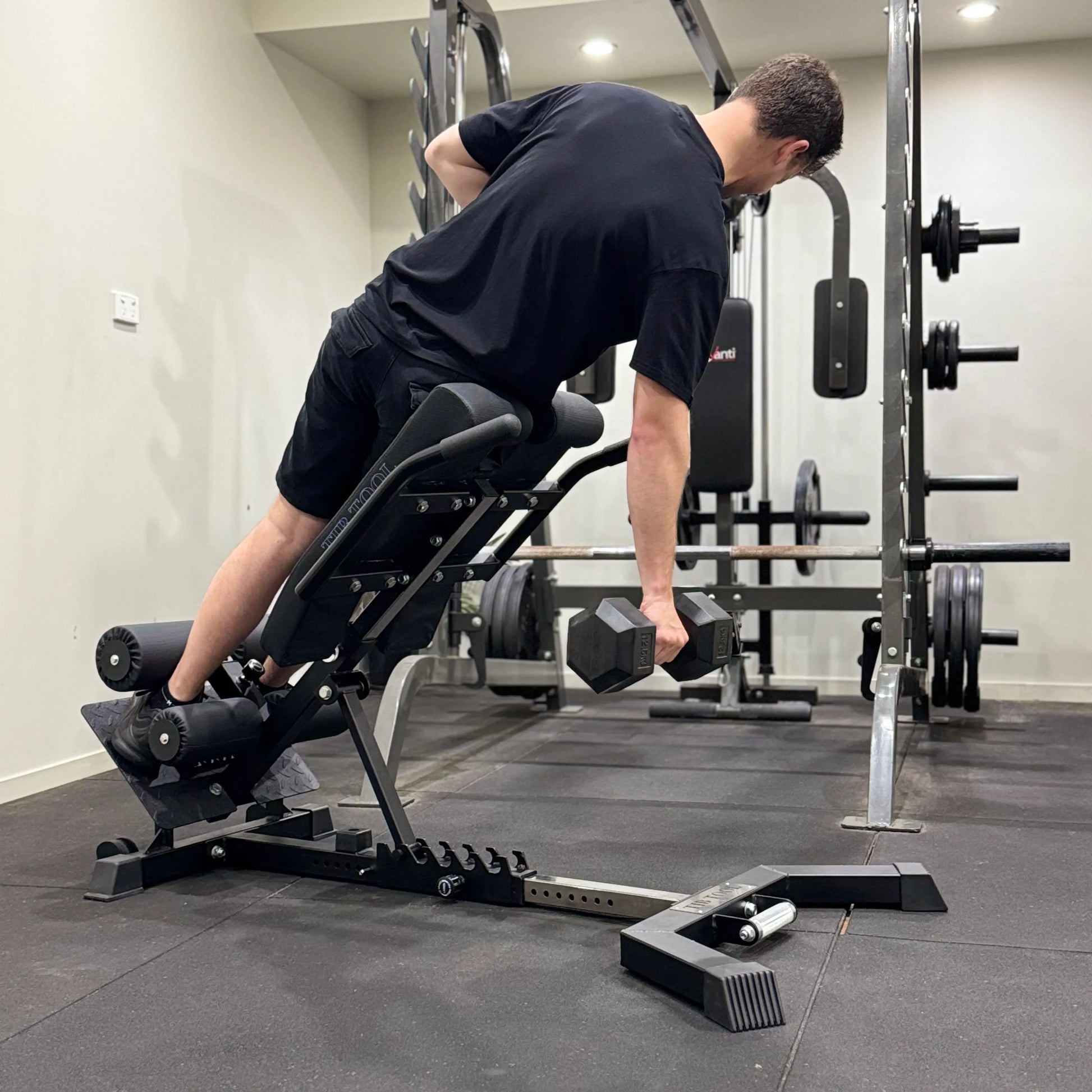 Person using a weight bench in a gym setting