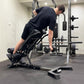 Person using a weight bench in a gym setting