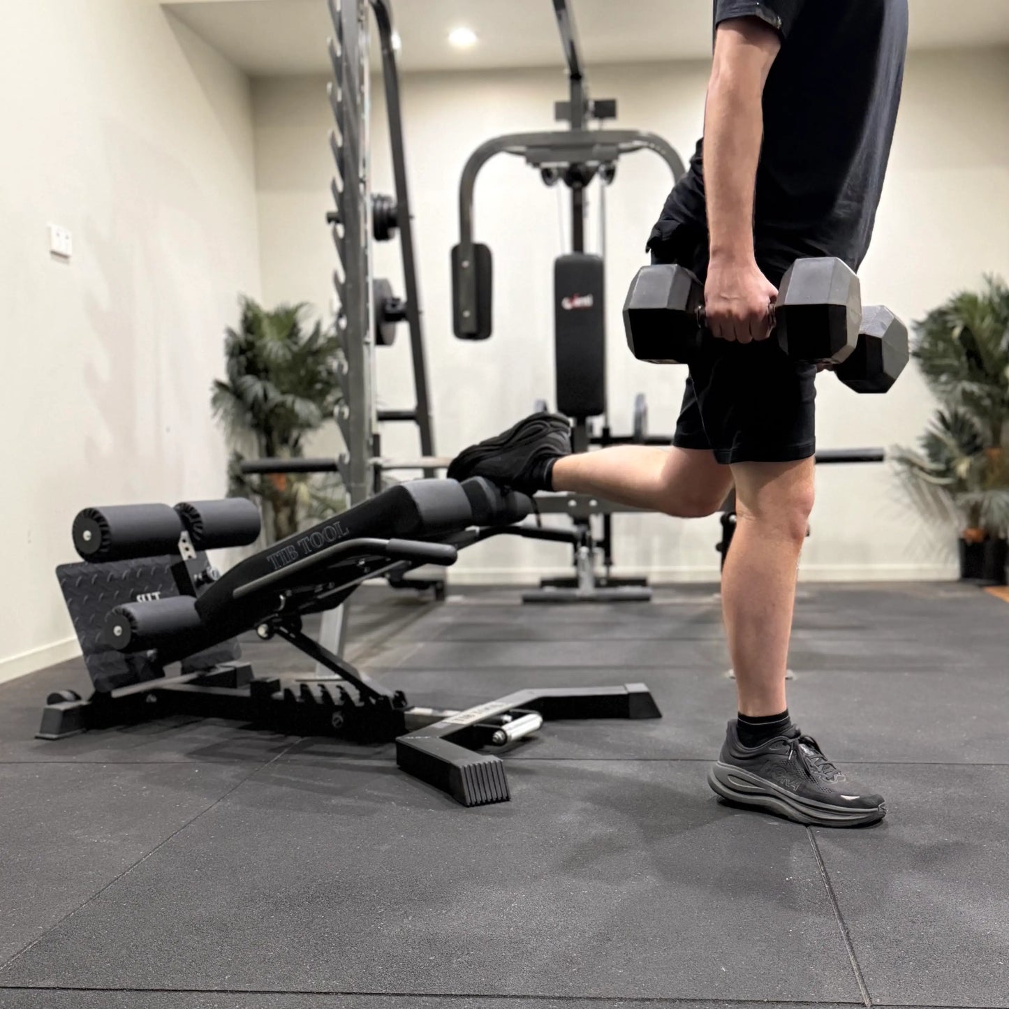 Person performing split squats using a split squat stand.